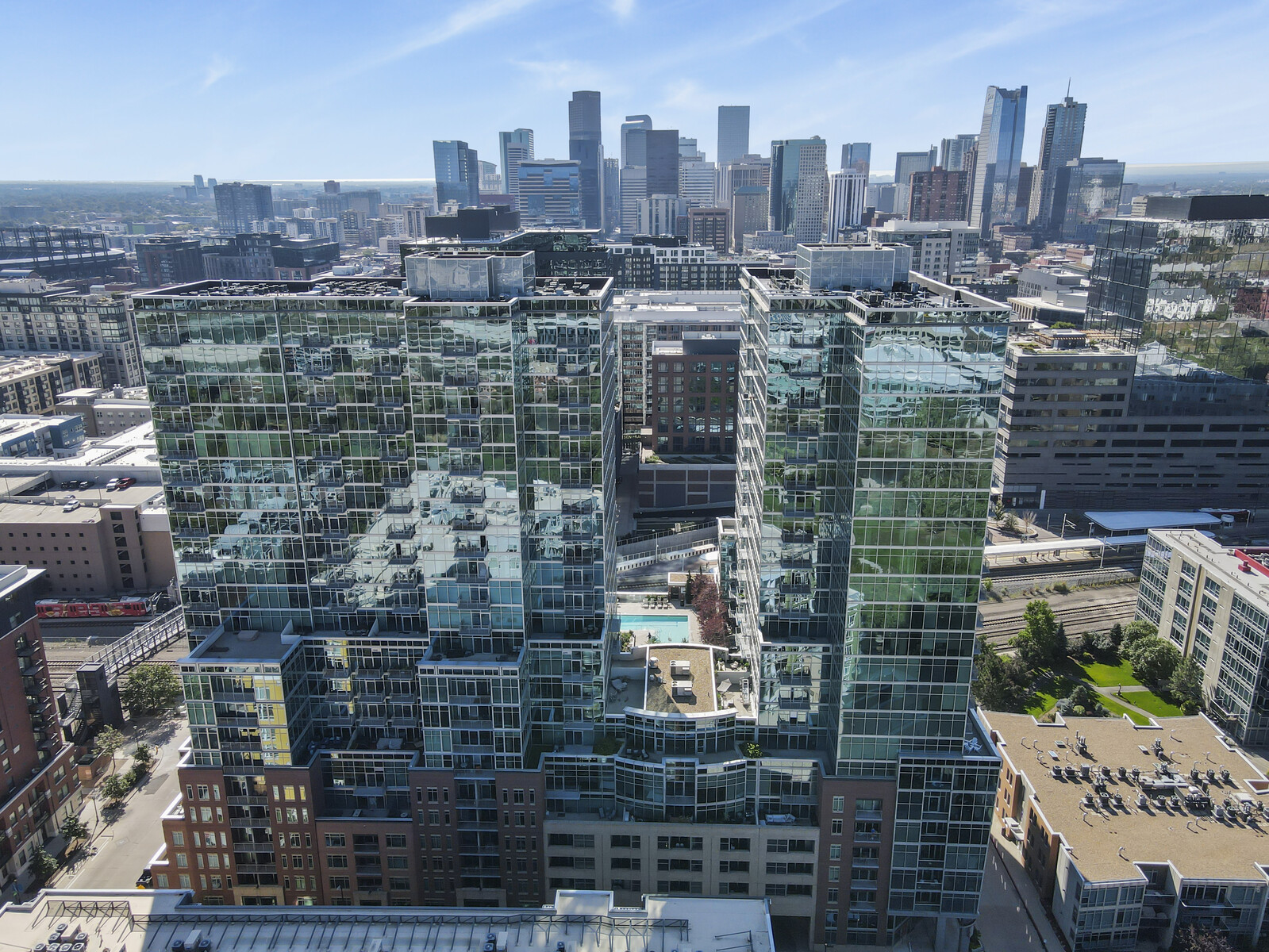 Denver skyline behind the glass towers at Dan’s past Bassett Street listing